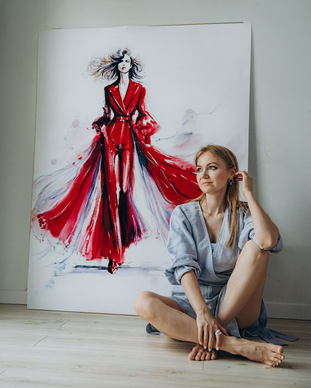 Watercolor fashion illustration of a woman in a red couture dress